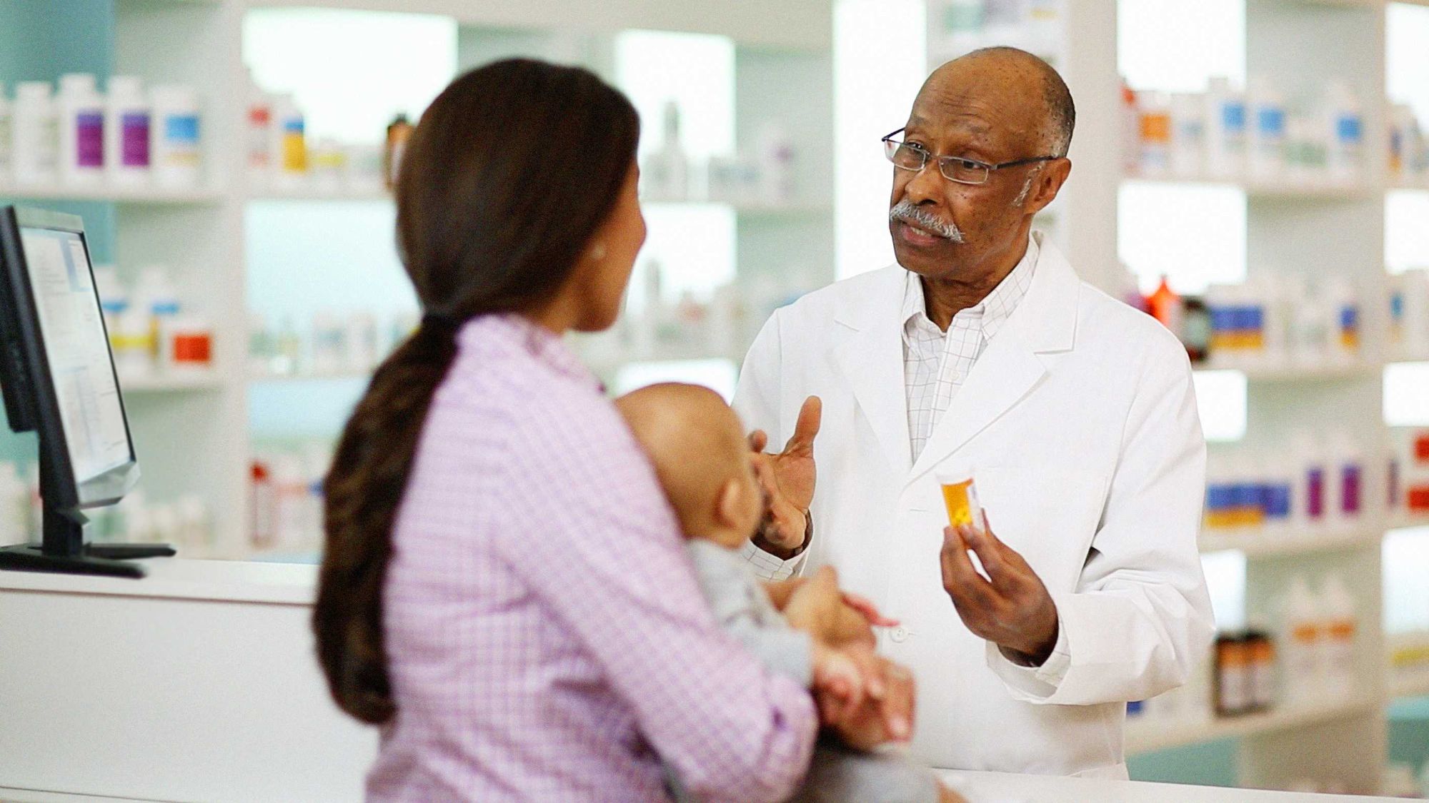 Pharmacist talking to patient.