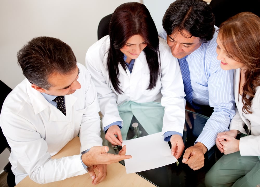 Business people negotiating medical insurance with a group of doctors