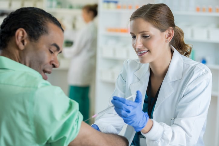 Pharmacist giving vaccination...