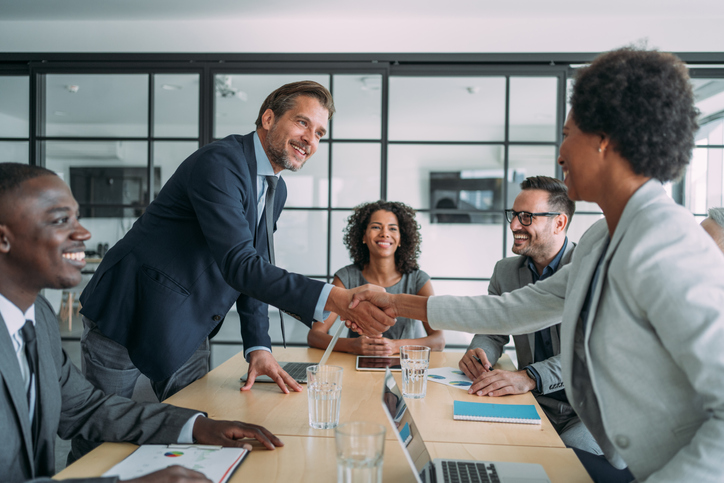 Partners shaking hands at a business meeting. 