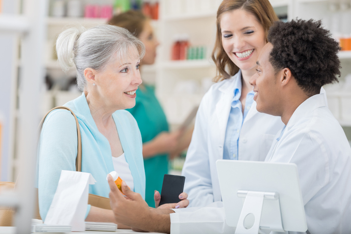 Pharmacist reviewing patient education with patient.
